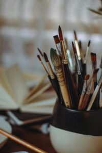 A variety of paintbrushes in a jar, representing creativity and artistic expression.
